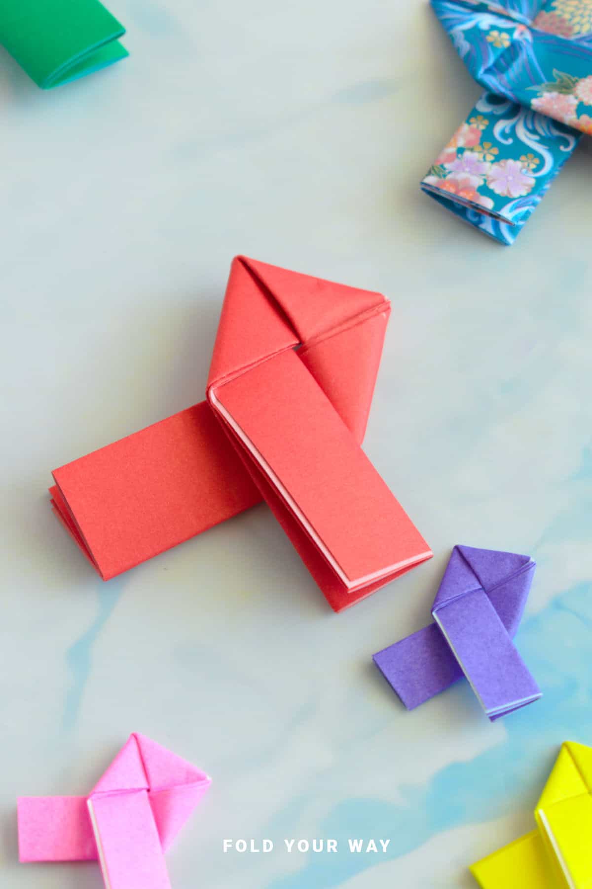 Red and purple origami lovers knots.