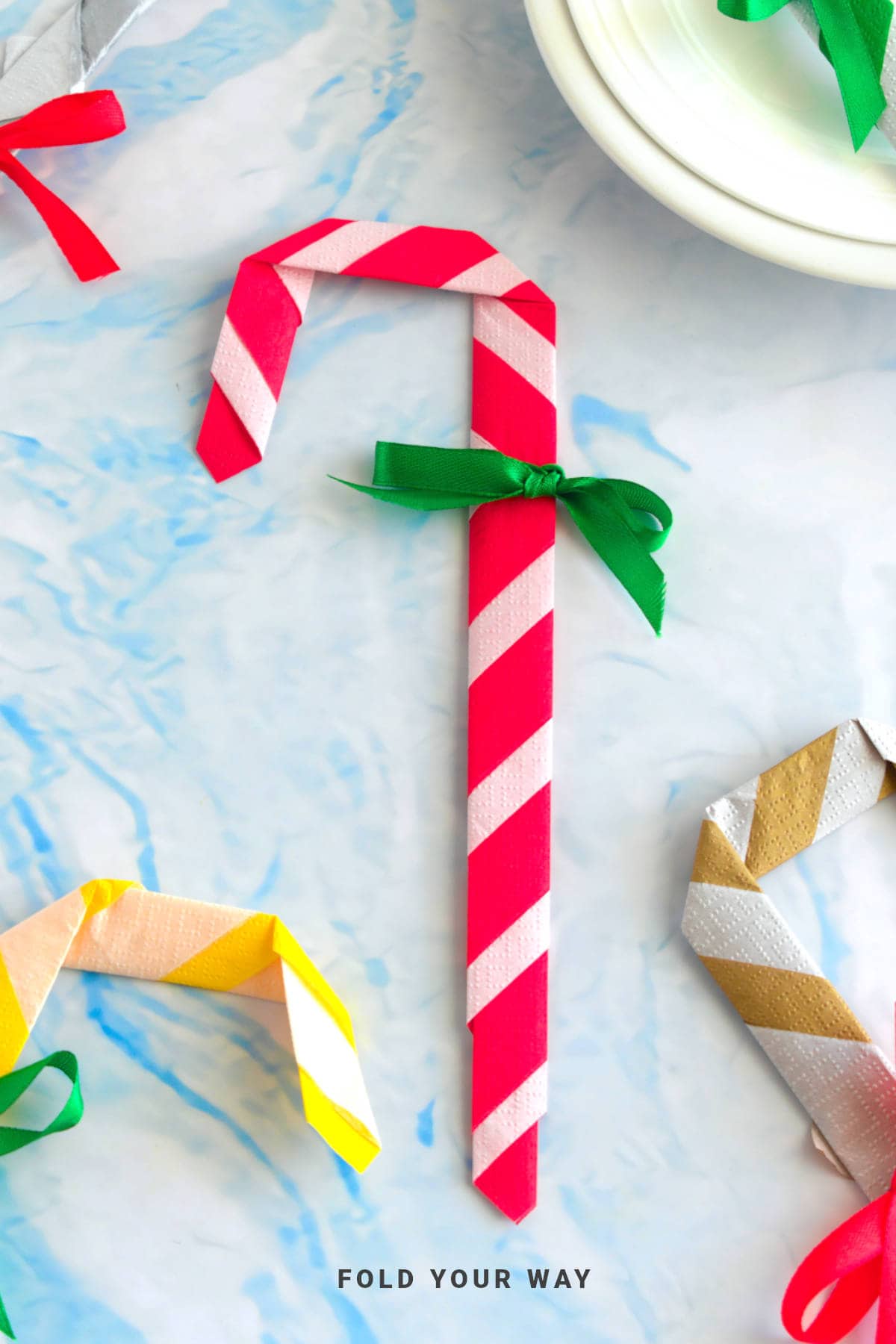Red and white candy cane napkin fold.