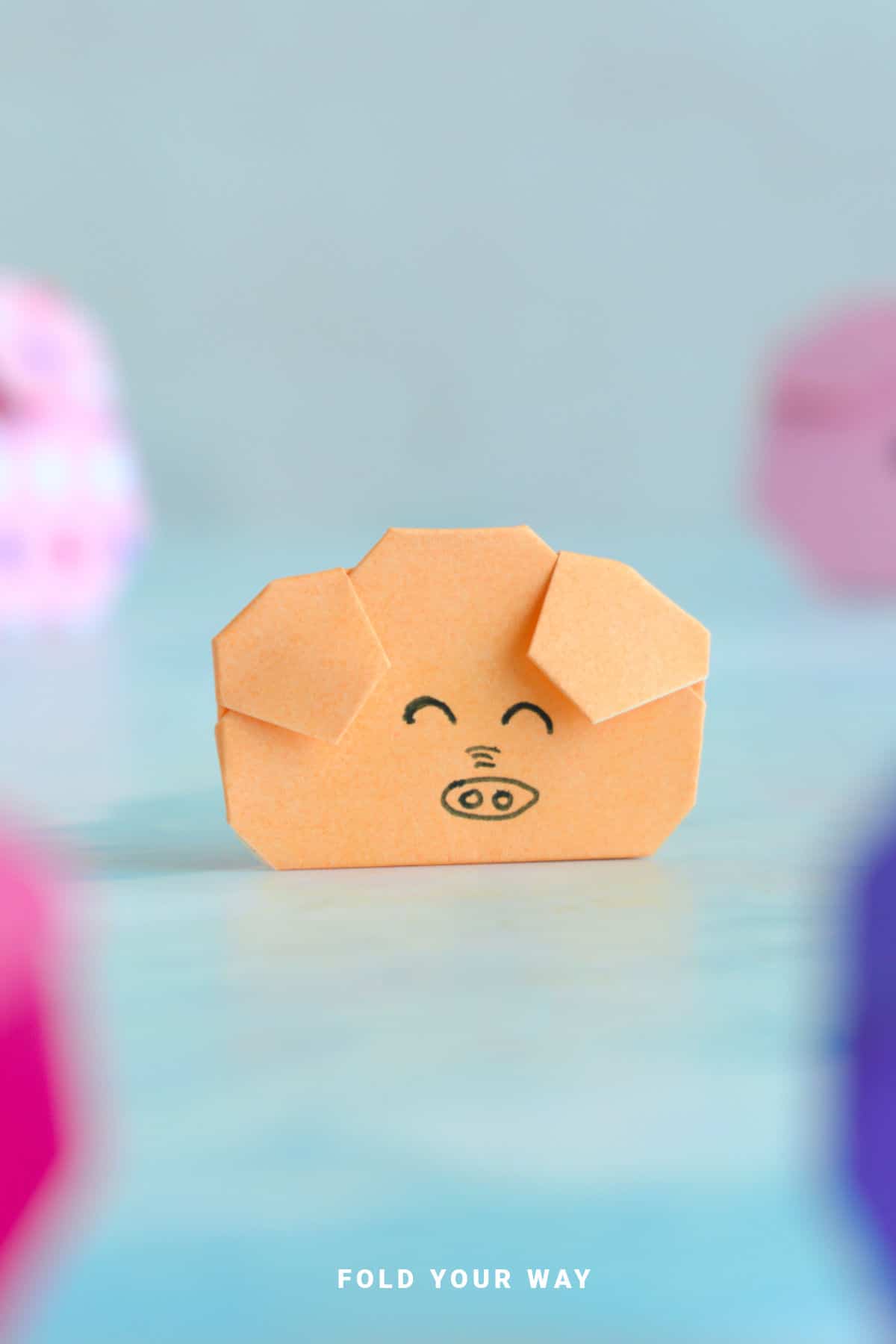 Close up image of an origami pig face.
