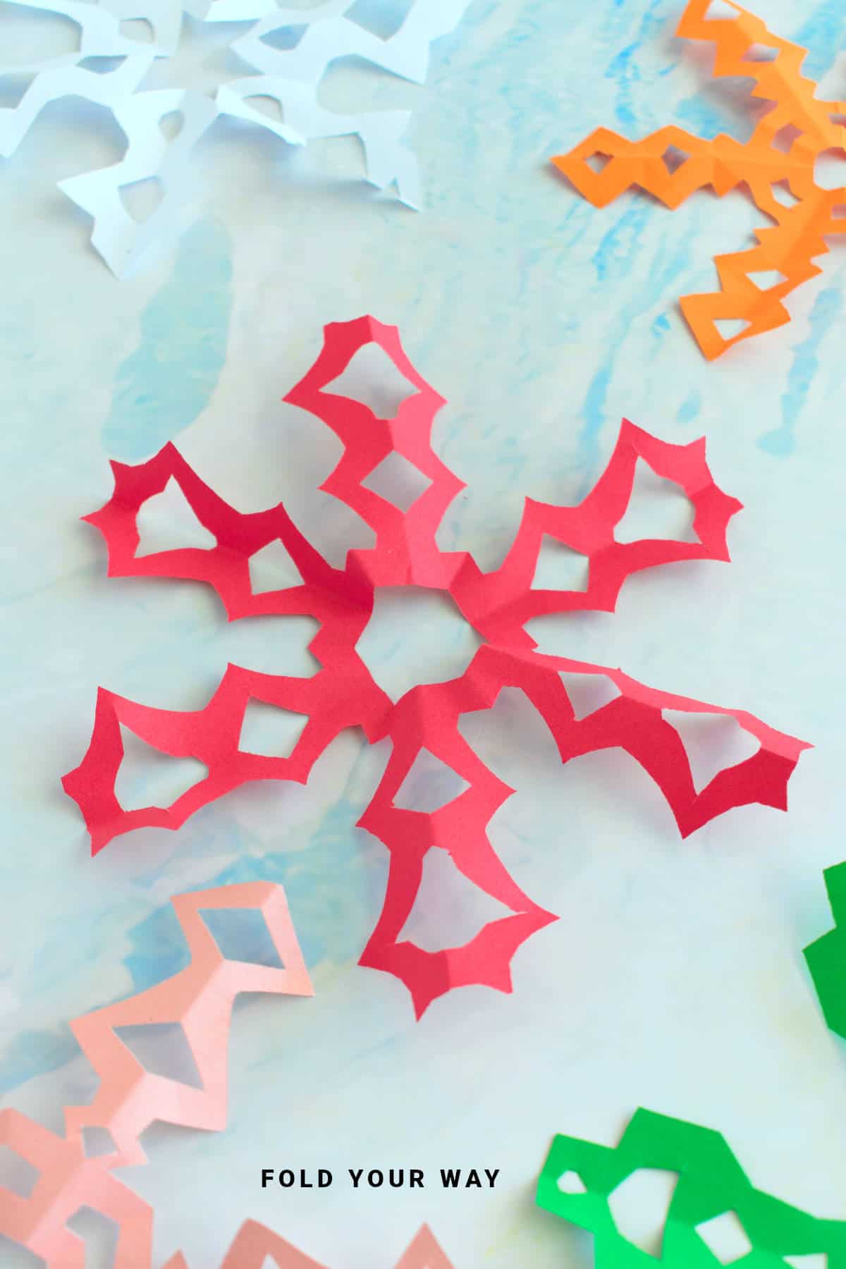 Close up image of a red paper snowflake.