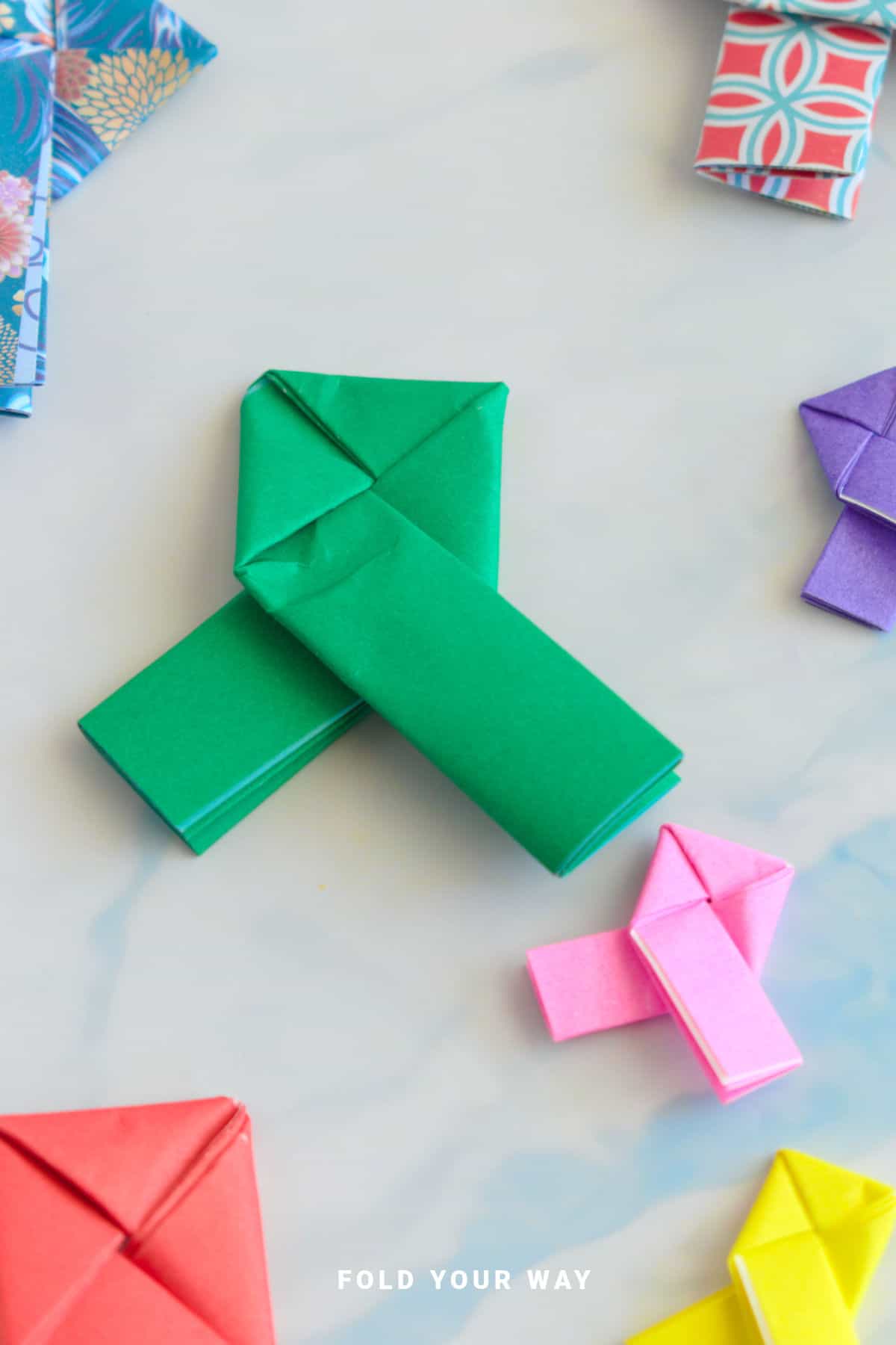 Green and pink origami lovers knots.