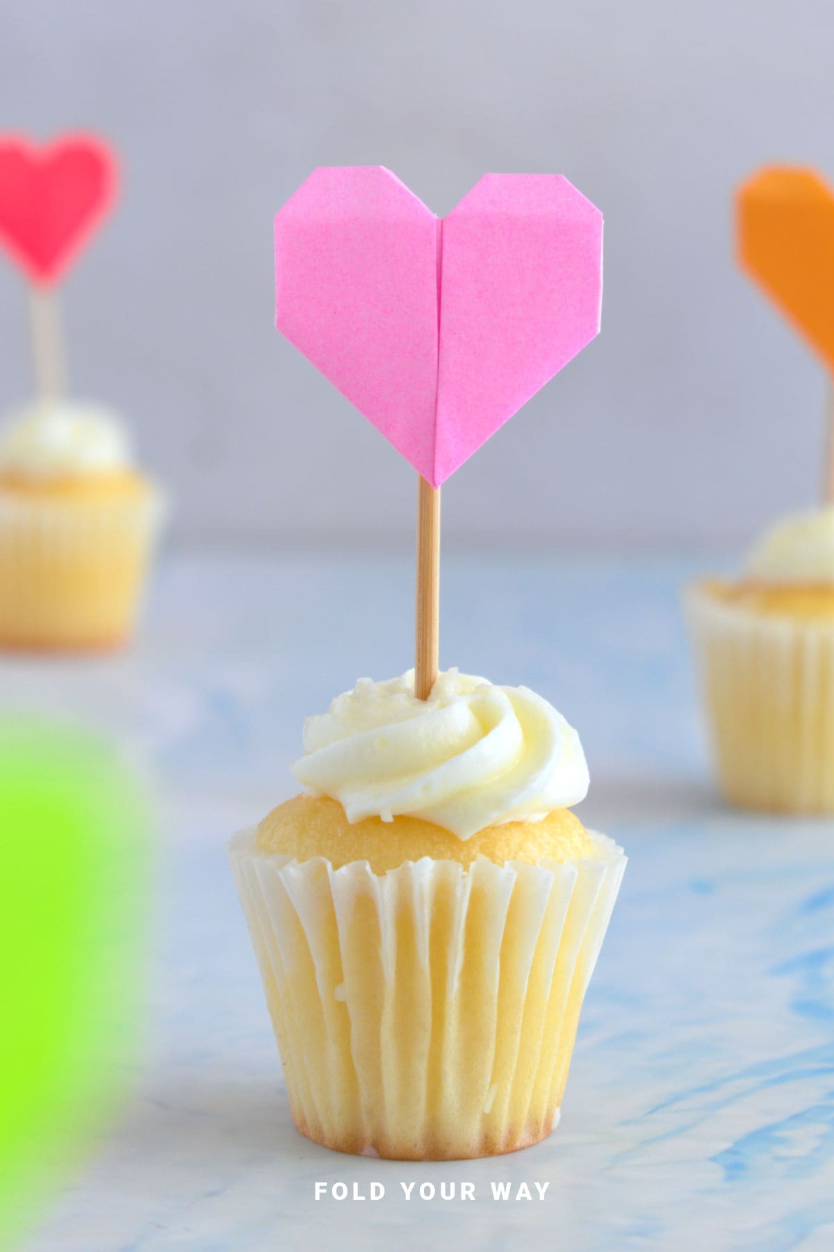 Heart cake topper on a cupcake.