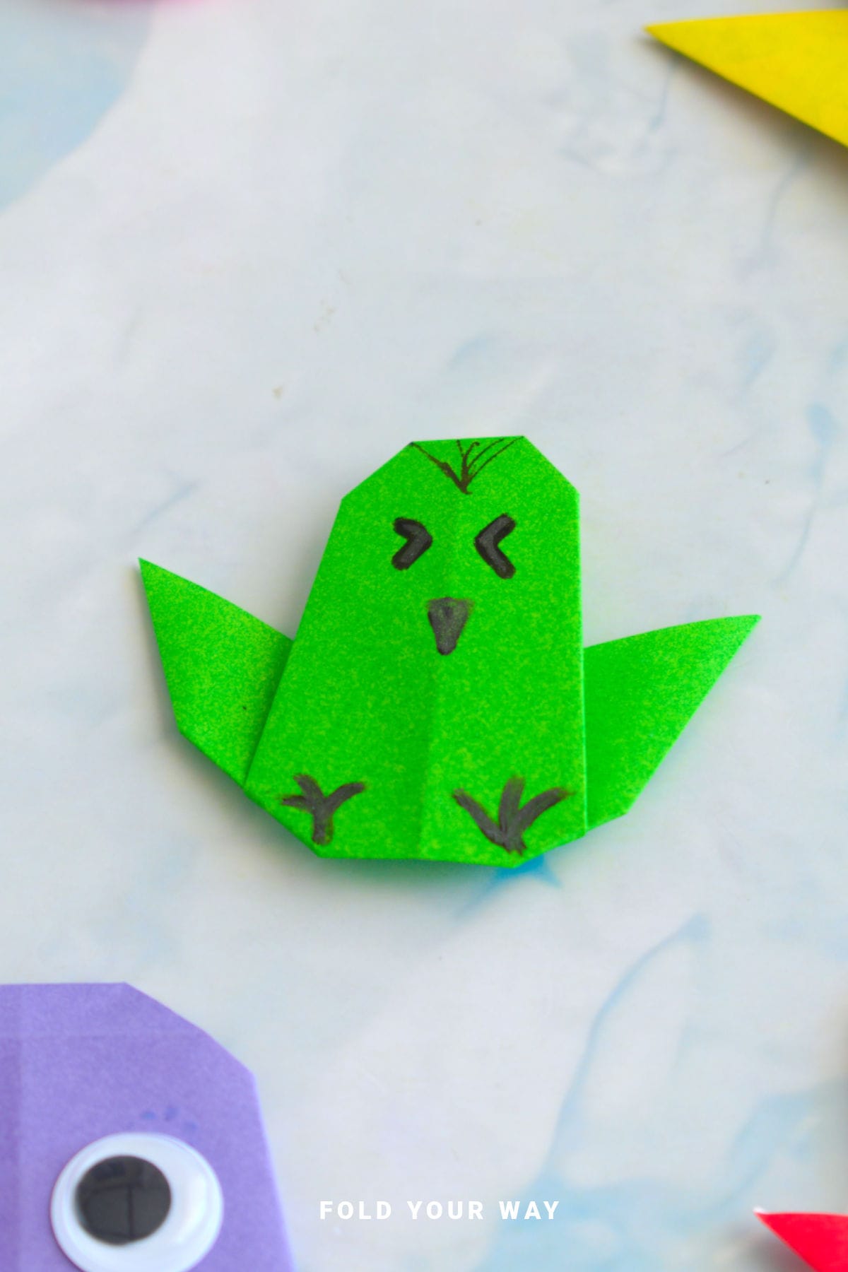 Green origami chicken.