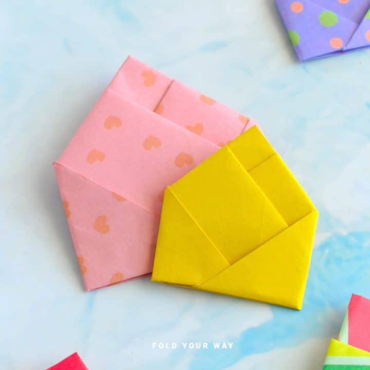 Pink and yellow origami letterfolds.