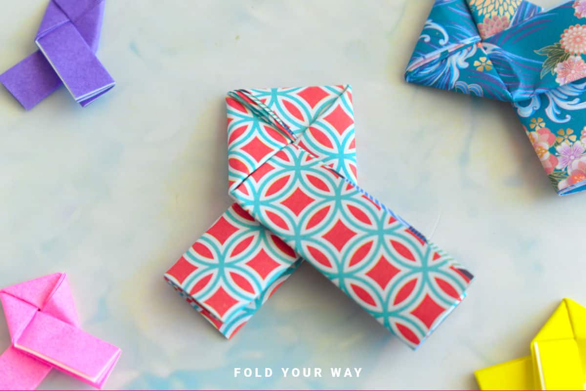 Red and blue origami lovers knot.
