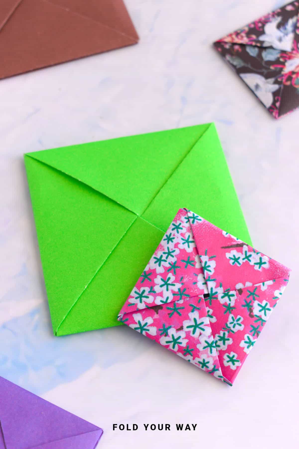 Close up image of square origami envelopes.
