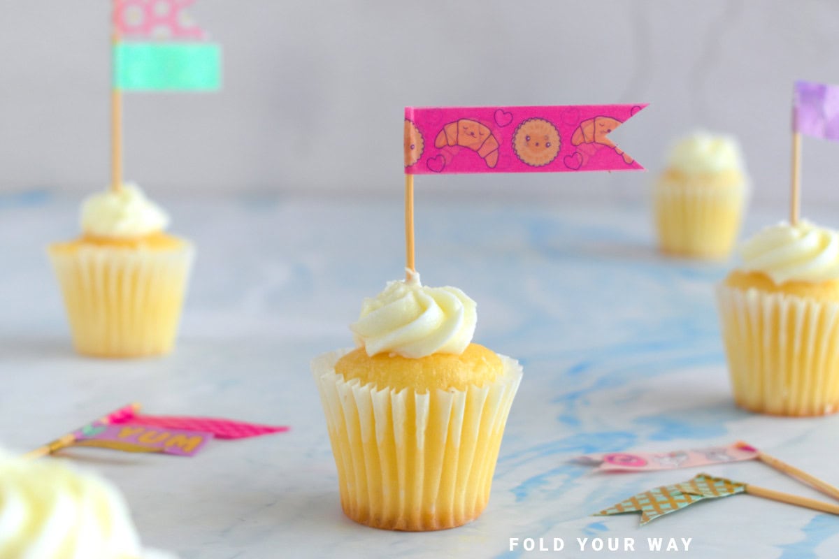Pink and brown washi tape cake topper on a cupcake.