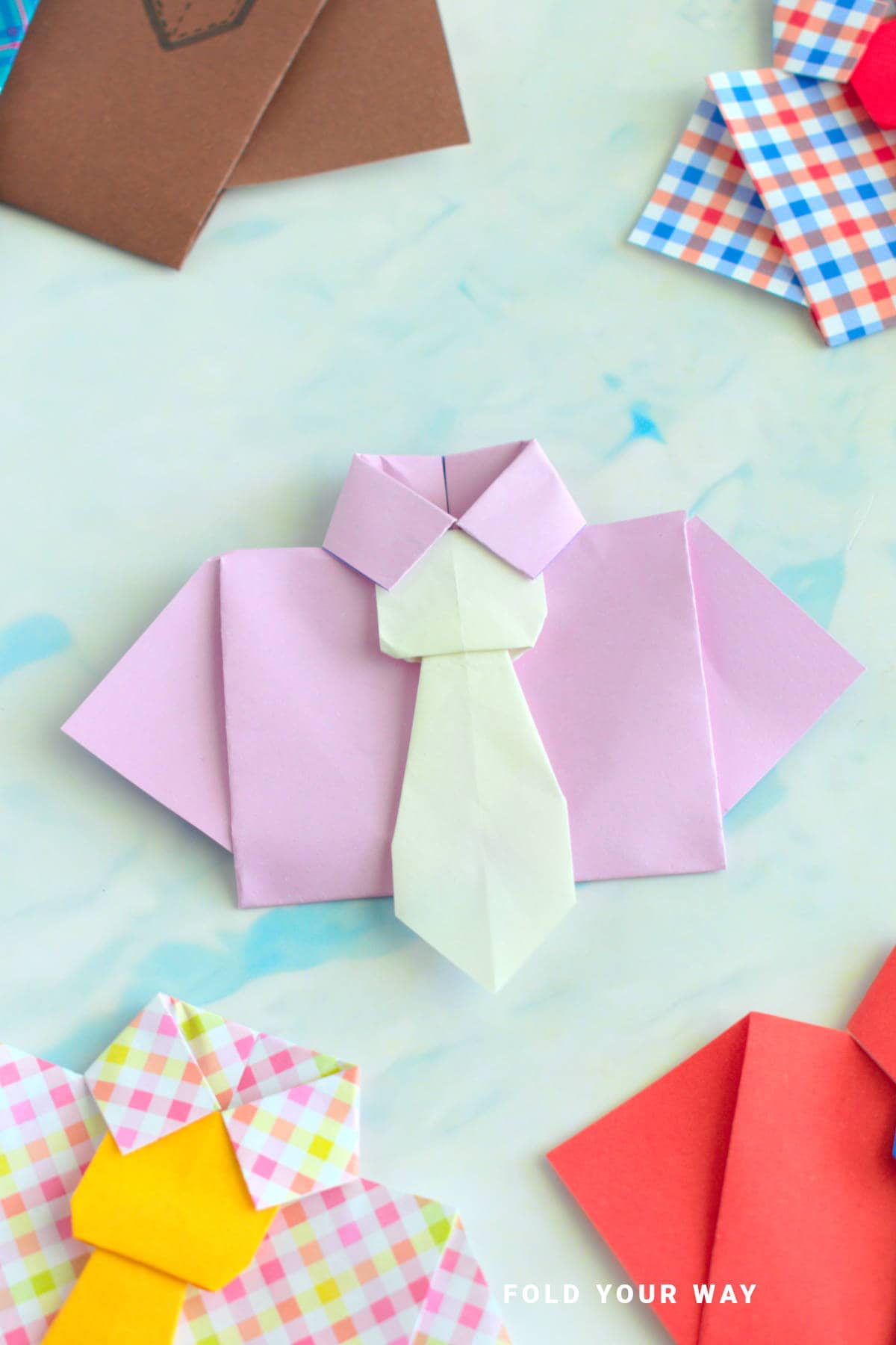 Pink origami shirt with white tie.