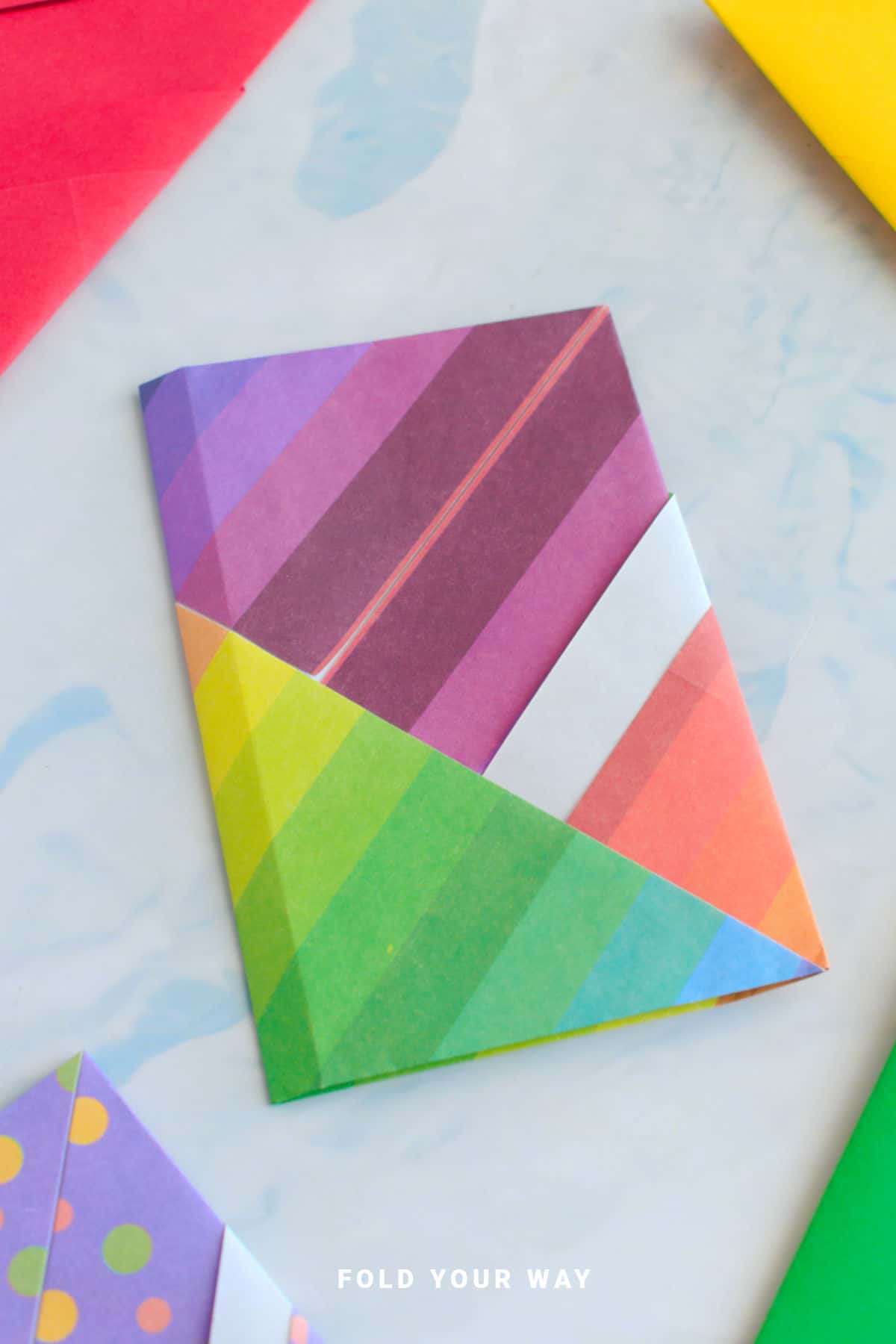 Striped origami letter fold envelope.