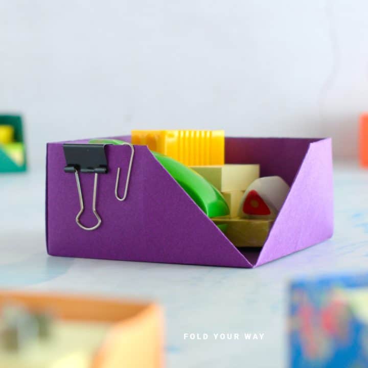Close up image of a purple origami desk organiser.