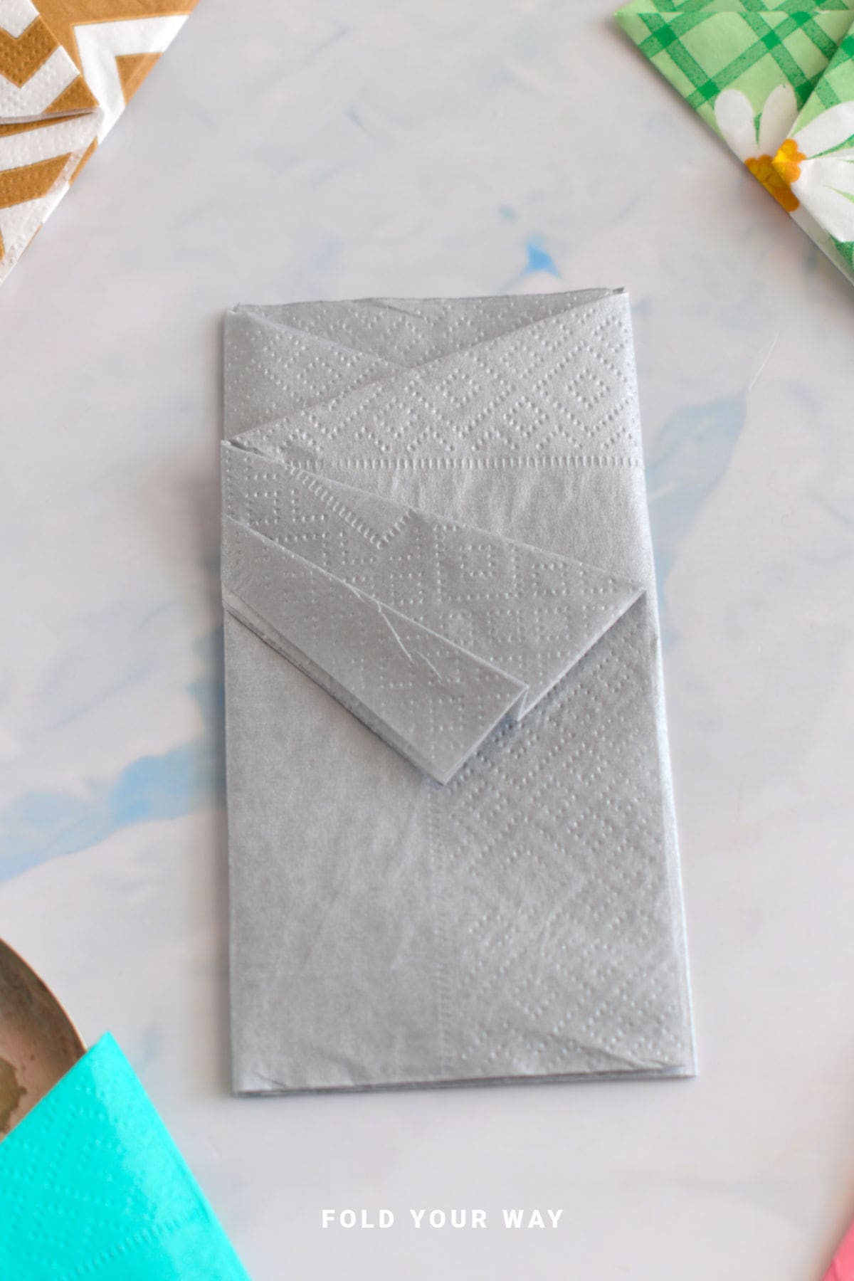Silver napkin fold.