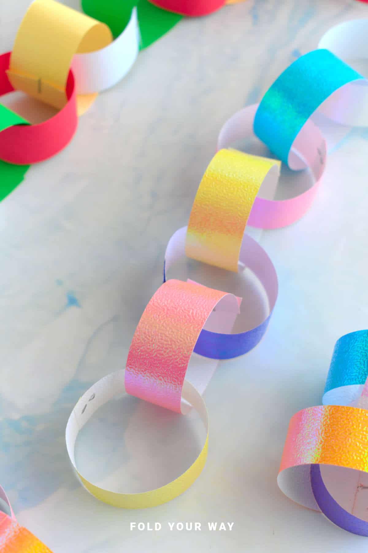Paper chains on a bench top.