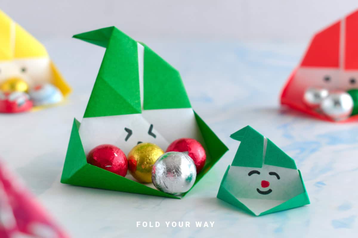 Close up image or origami Santa boxes.