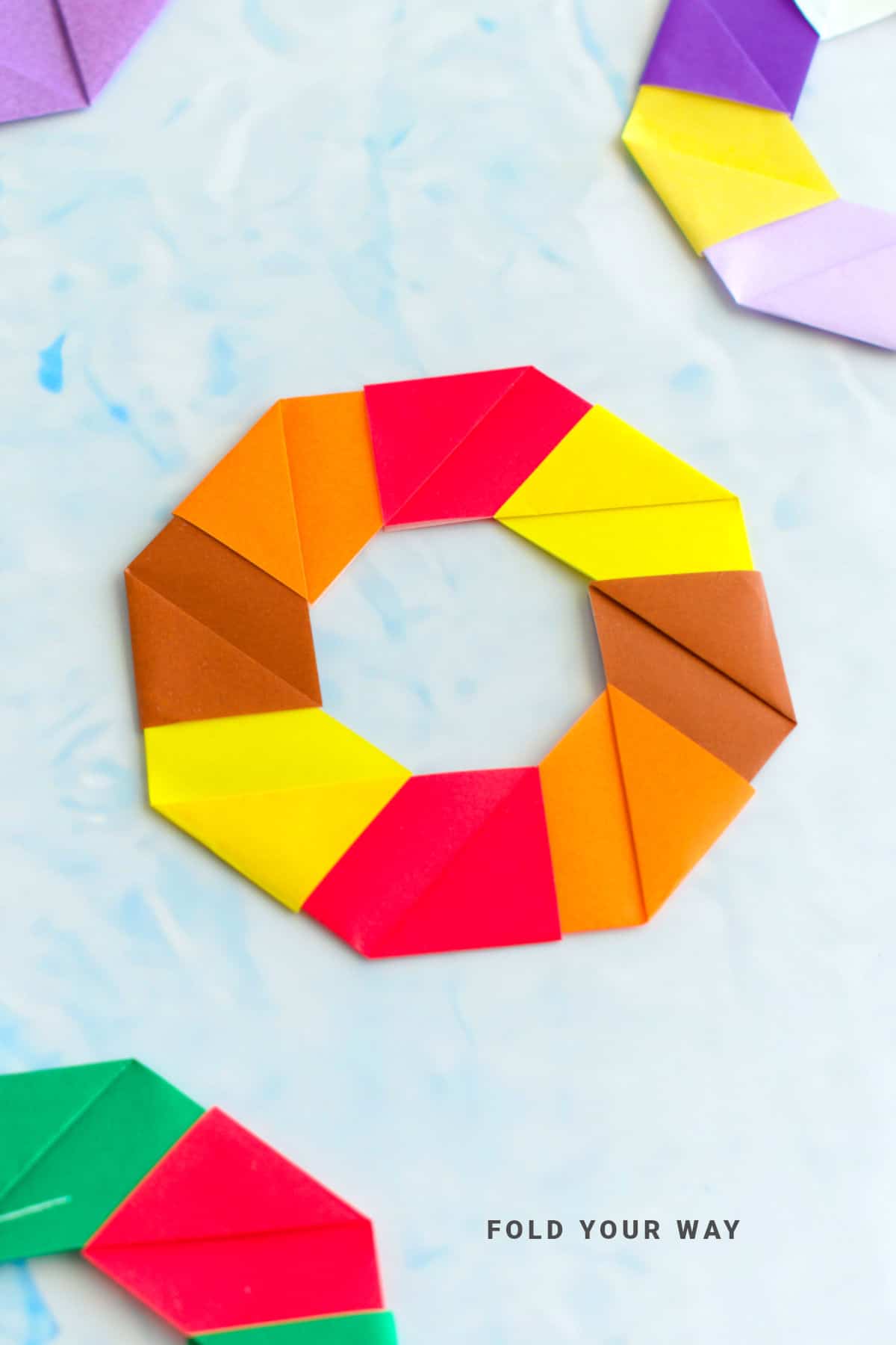 Orange, red, and yellow origami wreath.