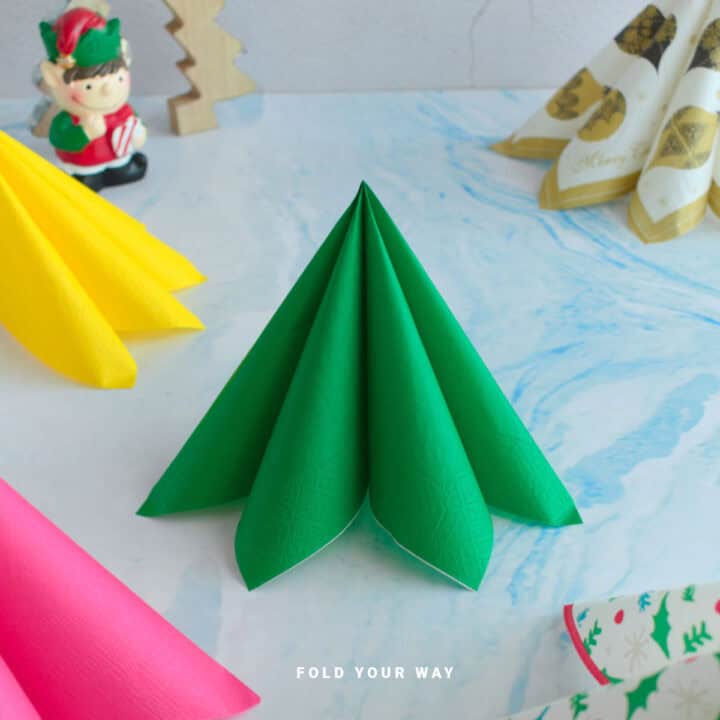 Close up image of a standing Christmas tree napkin fold.