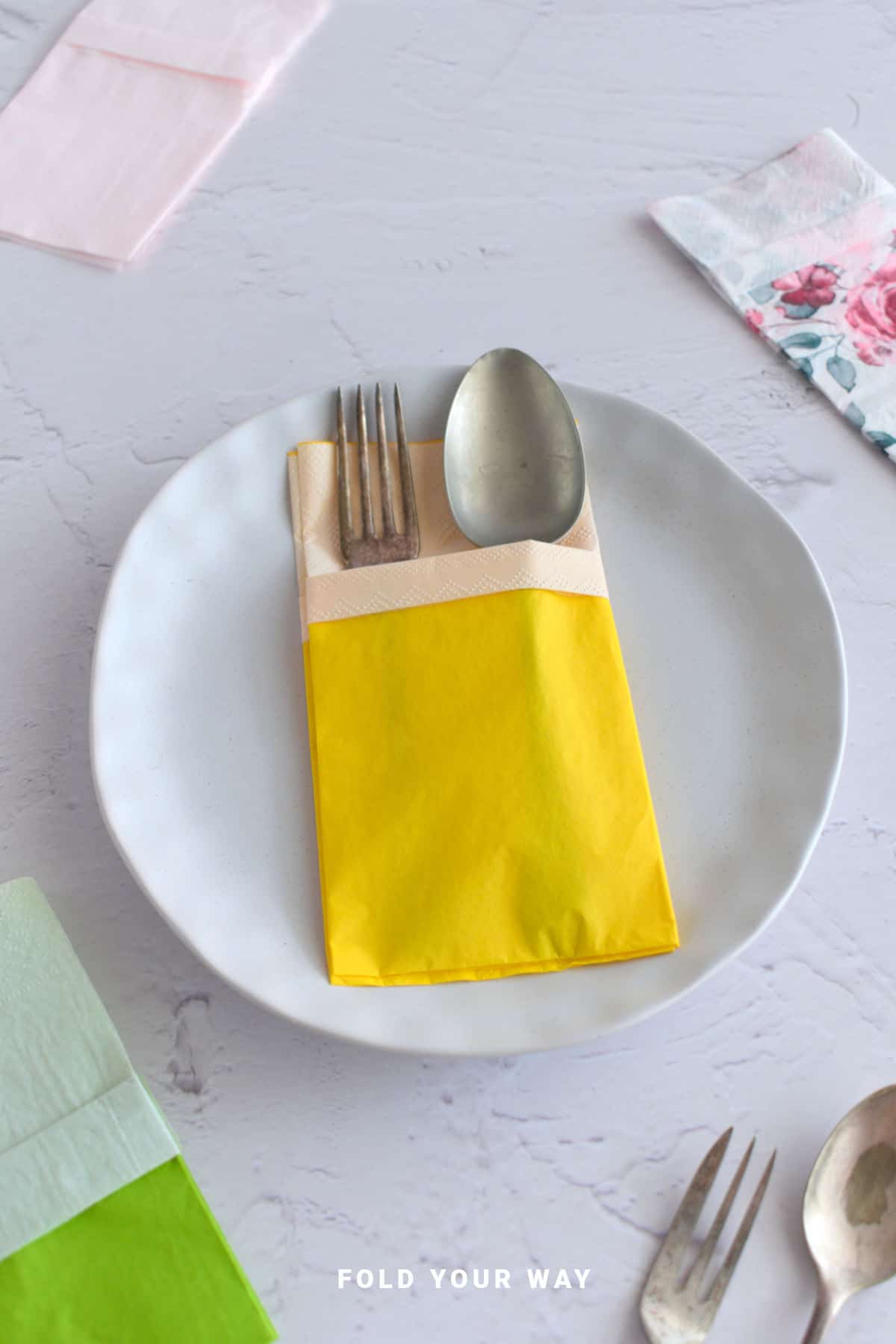 Yellow folded paper napkin.